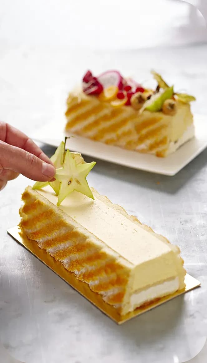 Chef decorating fruit entremets with star fruit