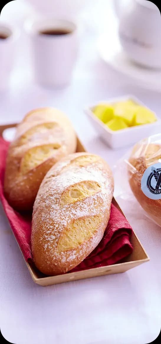 Two floured baguettes in a paper tray