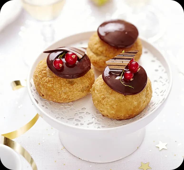 Chocolate glazed choux topped with cherries