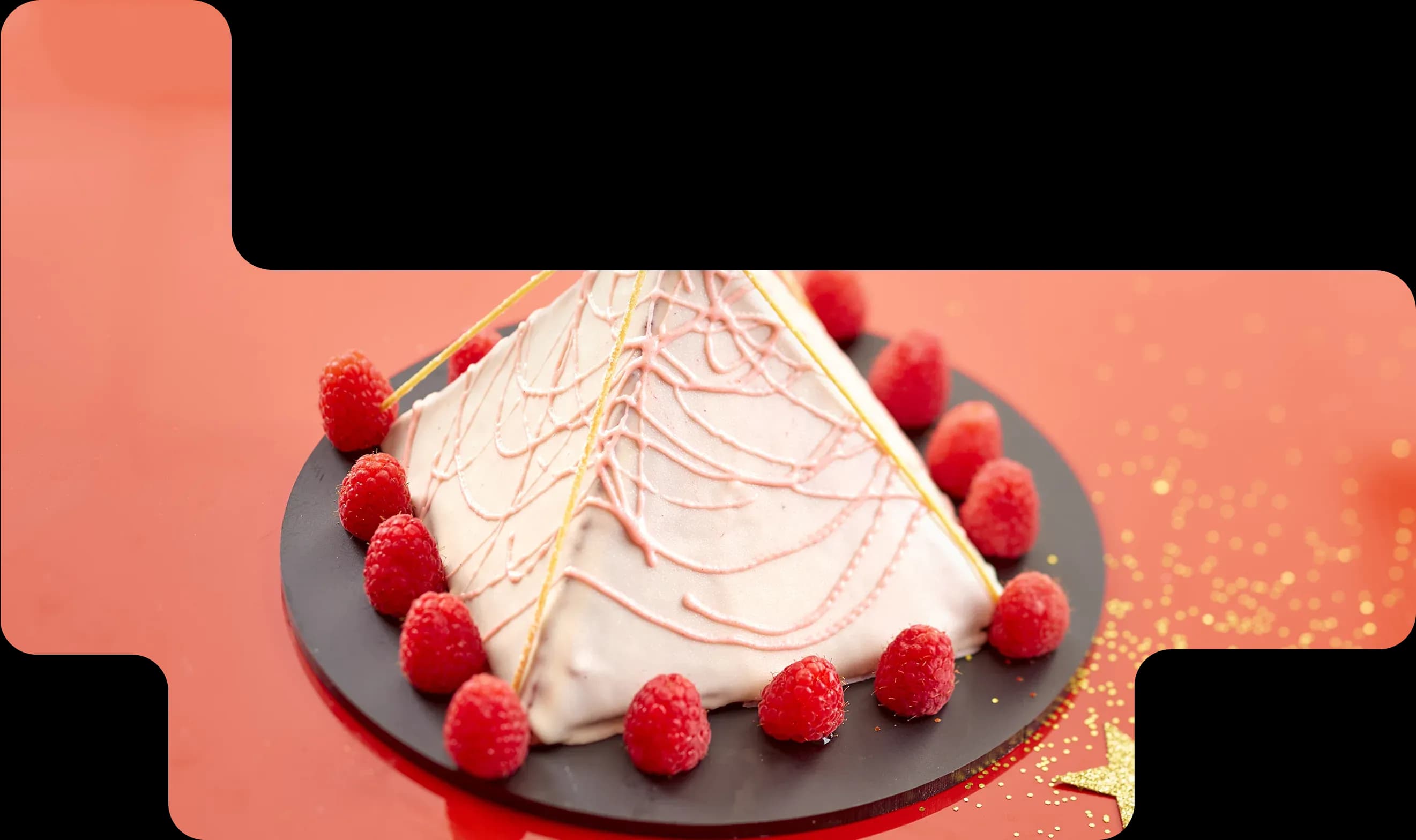Festive pyramid dessert decorated with raspberries