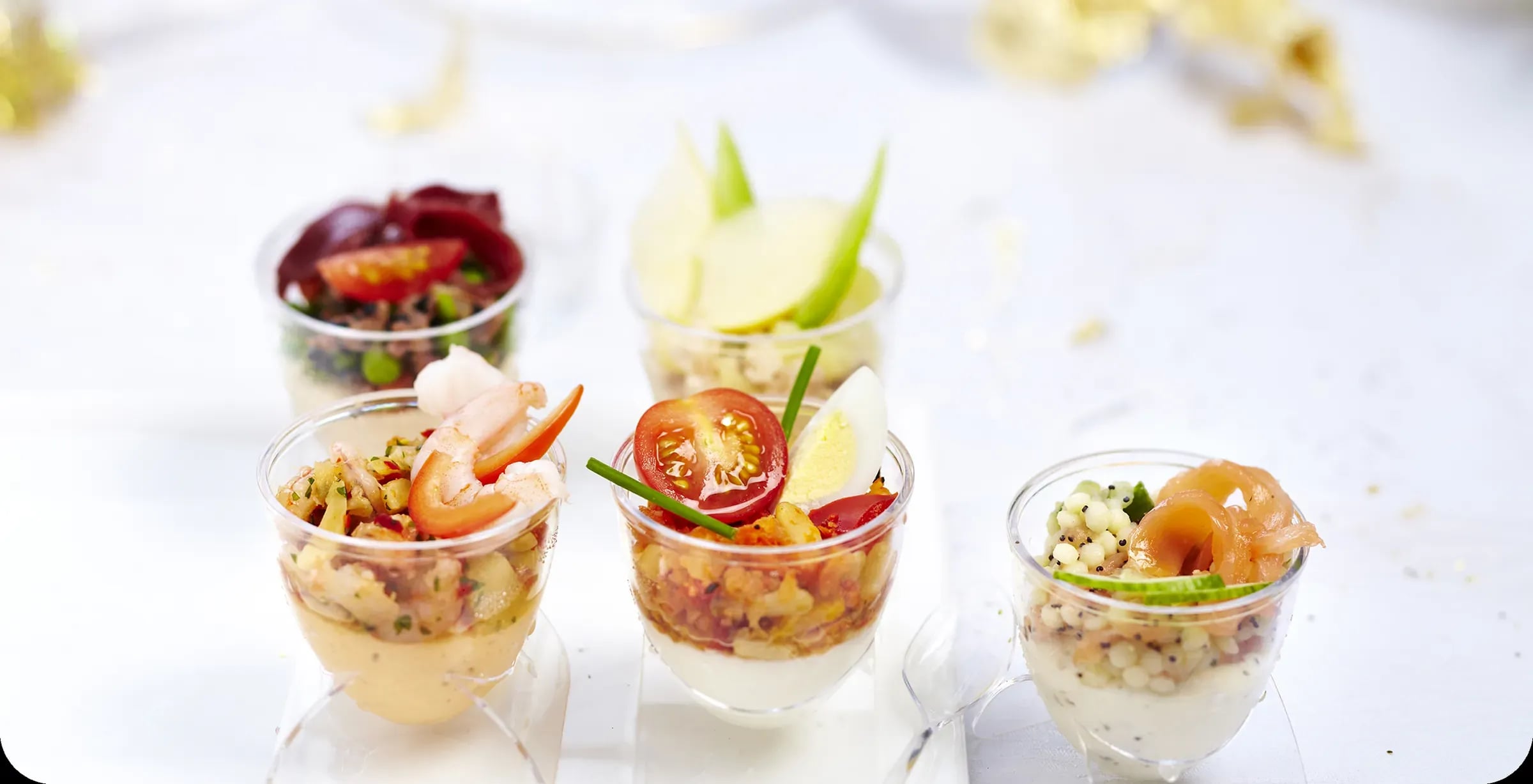 Verrines of prawns, tomato and egg, salmon and pearl couscous